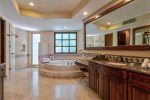 Master en suite bathroom with tub, one interior and exterior shower